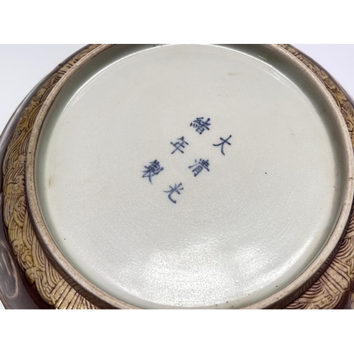 405 - A Chinese plum coloured dish with incised yellow decoration to the outside of dish with birds etc, m... 