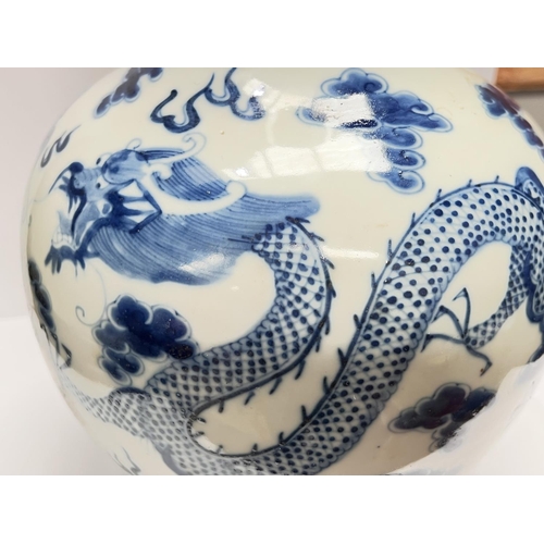 406 - A Chinese blue and white bottle vase decorated with dragons to the body, height 34.5cm, four charact... 