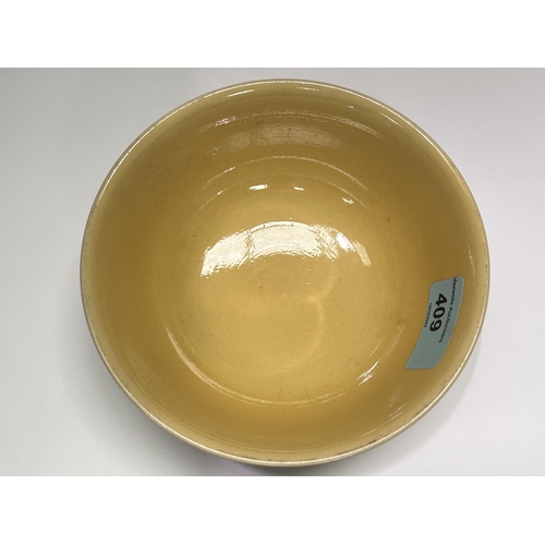 409 - A Chinese yellow bowl with dragon decoration in green to outside of bowl, six character mark to base... 