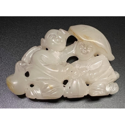 444 - A Chinese hardstone carved group of two children undercover, length 9cm