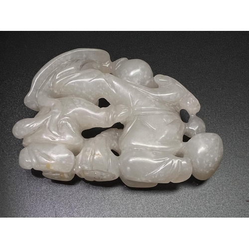 444 - A Chinese hardstone carved group of two children undercover, length 9cm