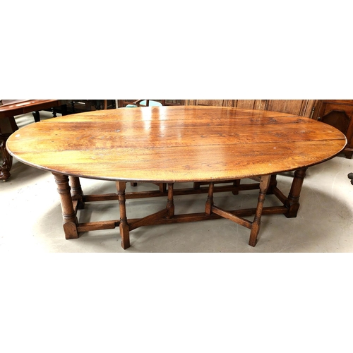 856 - An very large and impressive 18th century style oak wakes table on turned gun barrel legs length 245... 