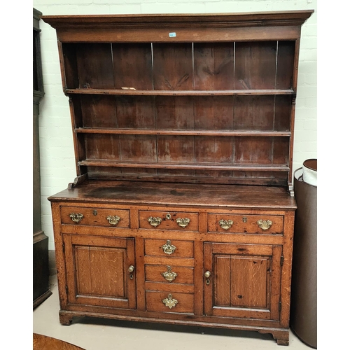 860 - An 18th century Country made Welsh dresser with 3 height delft rack over 3 frieze drawers, 2 side cu... 