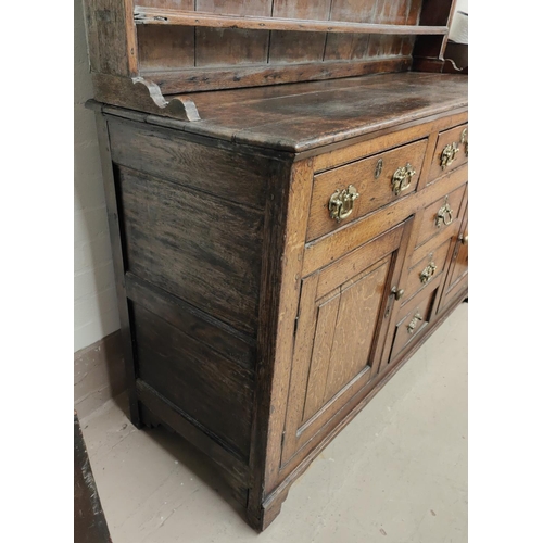 860 - An 18th century Country made Welsh dresser with 3 height delft rack over 3 frieze drawers, 2 side cu... 