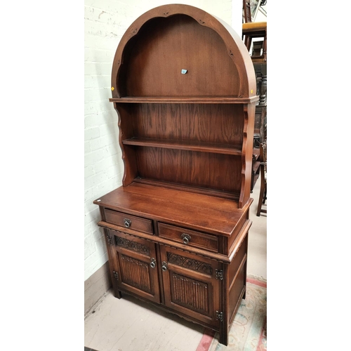 932 - An Old Charm oak reproduction Dutch dresser with 2 shelves over 2 drawers and 2 doors with linen fol... 