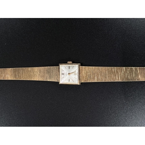 681 - A lady's Zenith wristwatch in 9 carat hallmarked gold case and integral strap, net weight 25gm