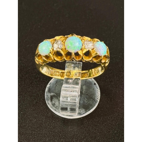 684 - An 18 carat hallmarked gold ring with 3 opals and 2 diamonds in split shank gypsy style setting, 4.9... 