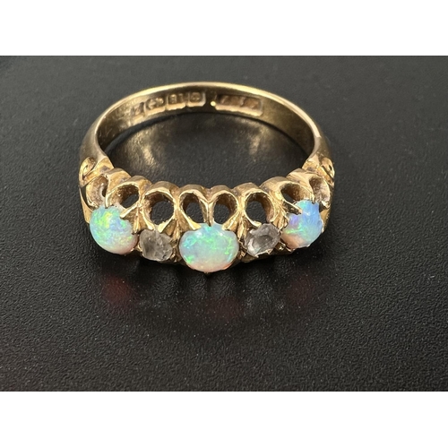 684 - An 18 carat hallmarked gold ring with 3 opals and 2 diamonds in split shank gypsy style setting, 4.9... 