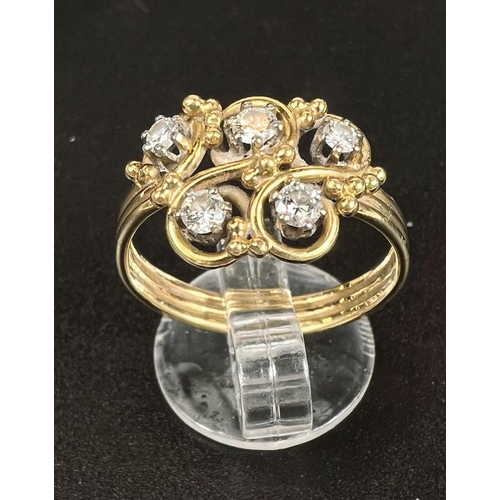 687 - An 18 carat hallmarked gold dress ring with 5 diamonds in scroll setting on ribbed shank, gross weig... 