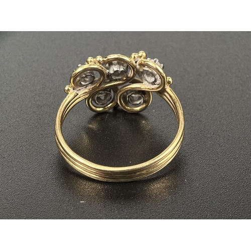 687 - An 18 carat hallmarked gold dress ring with 5 diamonds in scroll setting on ribbed shank, gross weig... 