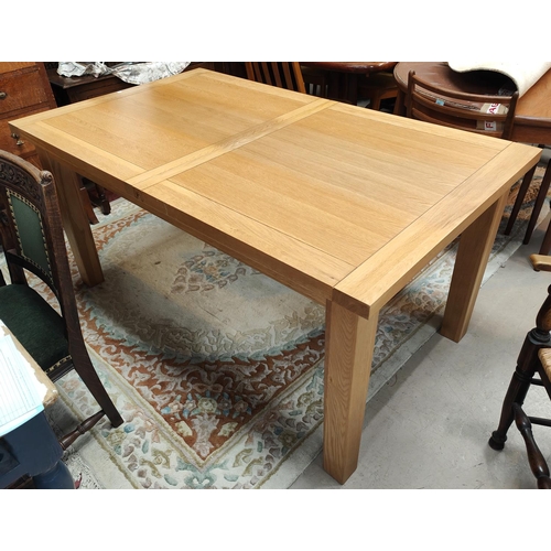 840 - A modern light oak dining table with extending rectangular top