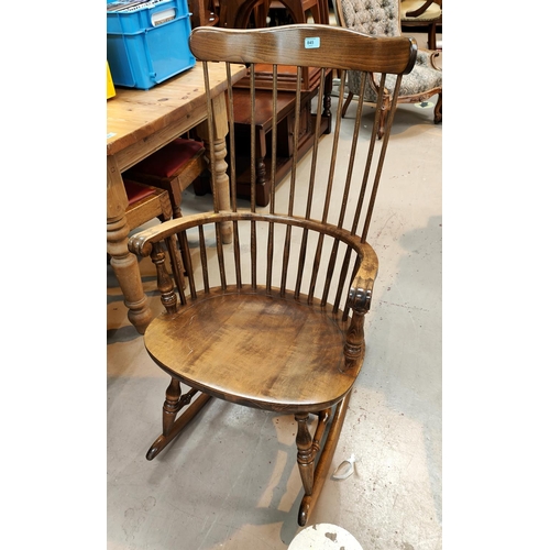 845 - A stained wood rocking chair with stick back