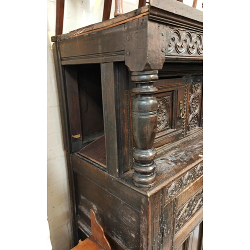 874 - A late 17th/early 18th century Deudarn with extensive carved decoration, the upper section with twin... 