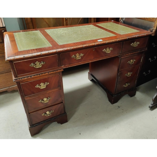 901 - A mahogany desk with green leather inserts, three frieze drawers, three pedestal drawers and pedesta... 