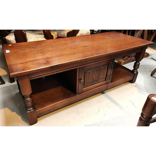 931 - An oak Old Charm occasional table with central cupboard, 122 x 51 depth x 47cm height; a Peter Scott... 