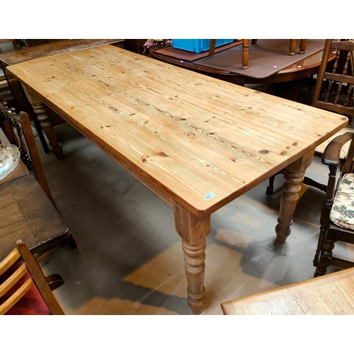 961 - A large rectangular country made pine kitchen table with turned legs, 211 x 83cm