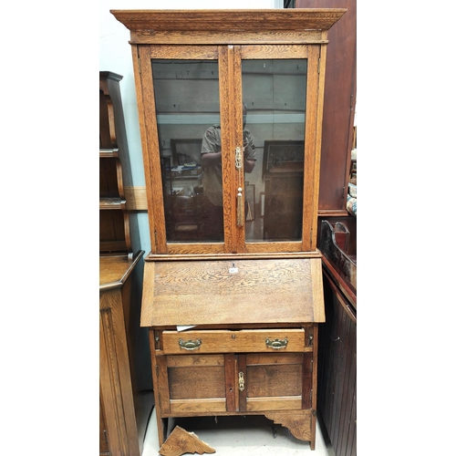 981 - An early 20th century oak bureau bookcase with glazed upper section, fall front and drawers below