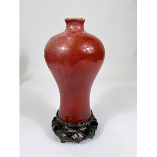 401 - A Chinese mei-ping shaped oxblood glaze vase, height 17.5cm with hardwood stand (some crazing to bod... 