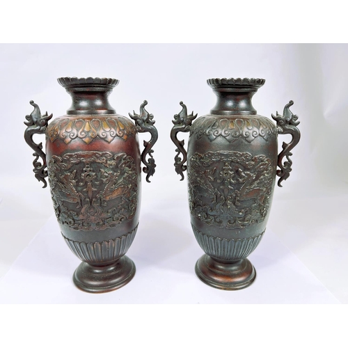 398 - A pair of Japanese bronze vases with relief decoration of dragons, dragon handles etc, ribbed rims, ... 