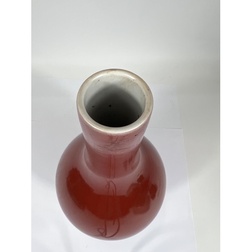 402 - A Chinese oxblood glazed bottle vase, with seal mark to base, hard wood stand, height 32cm