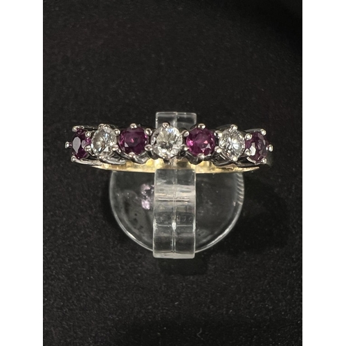 686 - An 18 carat hallmarked gold dress ring with 3 diamonds and 4 rubies in alternating setting, gross we... 