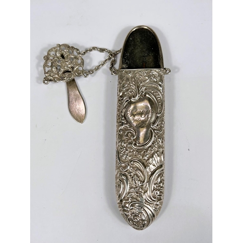 759 - A hall marked silver spectacles case with embossed scrolling floral decoration, with chain and hook,... 