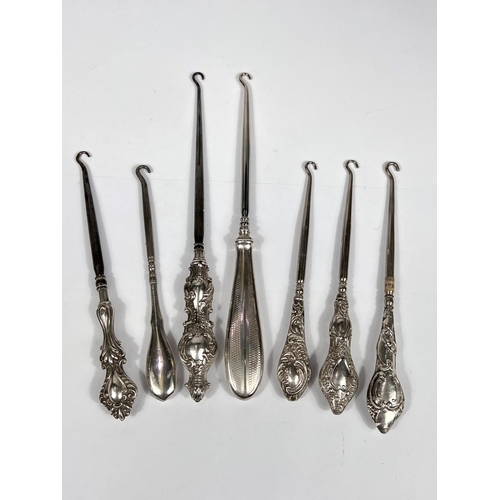 761 - Seven various silver hall marked button hooks with different designs, assay offices etc 