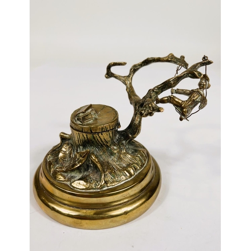 763 - A Victorian brass desk ink well in the form of tree stump with boy swinging from the branches 