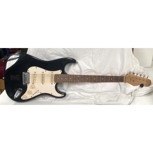 107 - A Fender style electric guitar with black body cream fittings