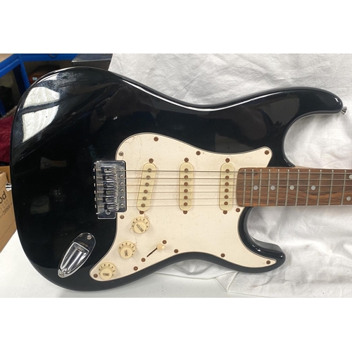 107 - A Fender style electric guitar with black body cream fittings