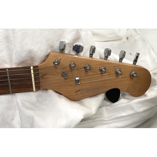 107 - A Fender style electric guitar with black body cream fittings