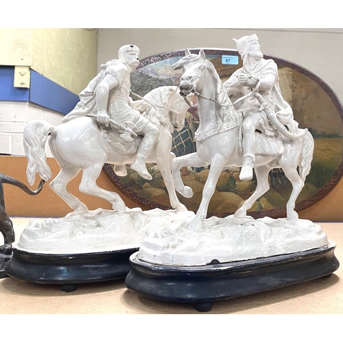 116 - A pair of white painted spelter figures:  knights on horseback; a pair of bronzed lions