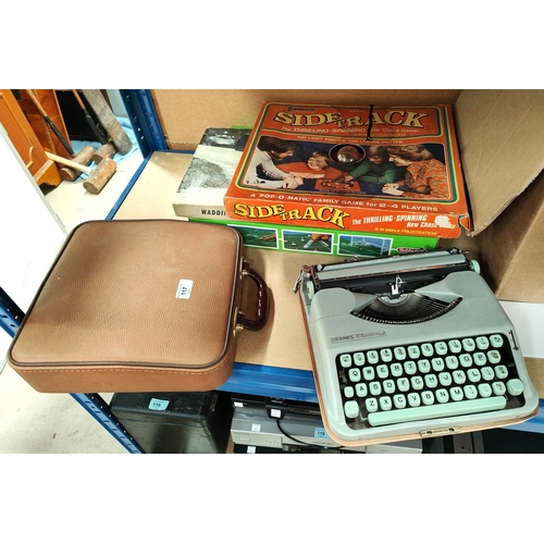 117 - A 1950's Hermes portable typewriter with original receipt; a selection of vintage games; etc.