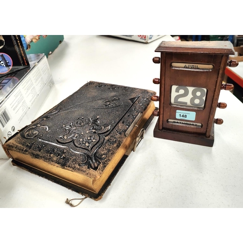 148 - A late Victorian photograph album with ornate cover (empty and spine missing); a stained wood perpet... 