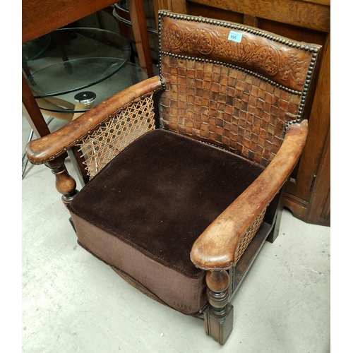 995 - An early Ercol low seat armchair with woven + embossed leather back, cane sides & square legs, w... 