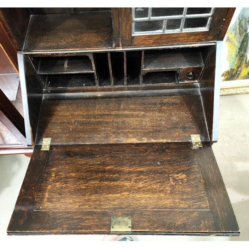 868 - A Liberty's small oak bureau with open shelves and mullion glazed cupboard, folding side shelf, and ... 