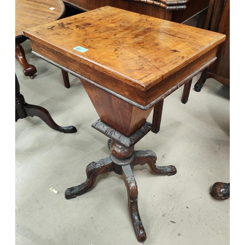 882 - A rectangular walnut work table with hinged lid and fitted interior tapering well & 4 carved scr... 