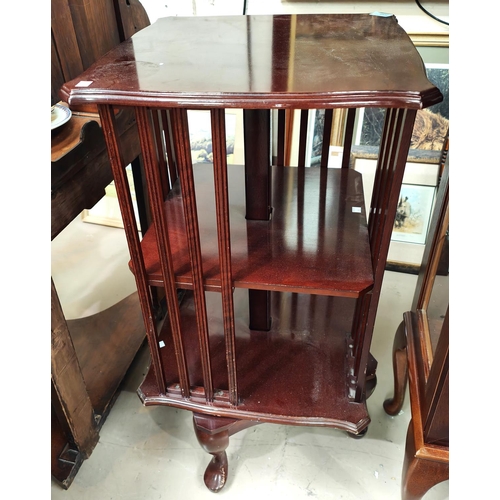 888 - A reproduction mahogany rotating book gallery book case on four legs, height 87cm