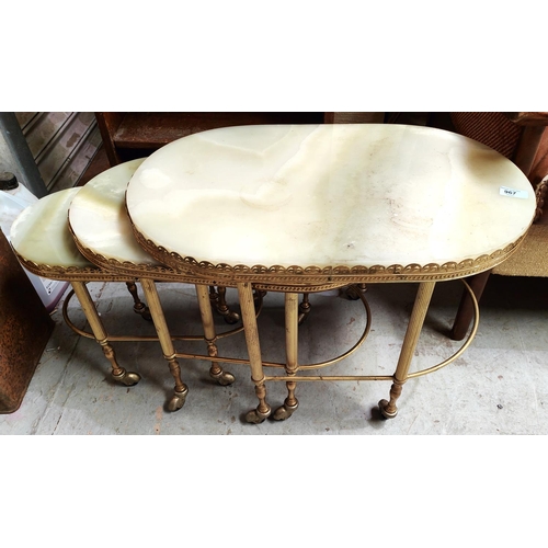 967 - A mid 20th century trio nest of onyx and gilt edged occasional trolley tables, on castors