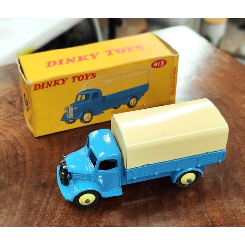 221 - An originally boxed Dinky:- 413 blue and cream Austin Covered Waggon.