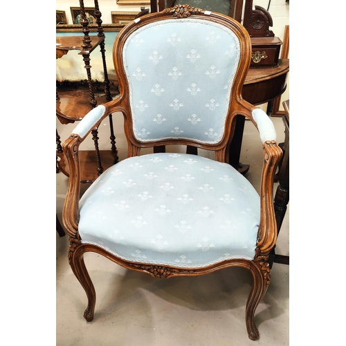 882A - A Louis XV style stained walnut armchair in light blue fabric