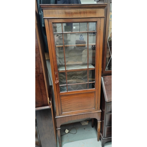 835 - An Edwardian narrow display cabinet in inlaid mahogany, enclosed by single door