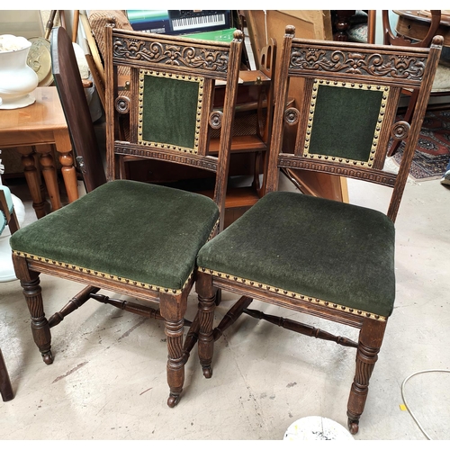 858 - A set of 4 Edwardian carved oak dining chairs with green dralon seats