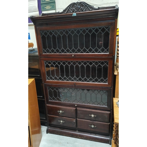 881 - An Edwardian mahogany sectional bookcase with 3 leaded glass doors and 4 drawers