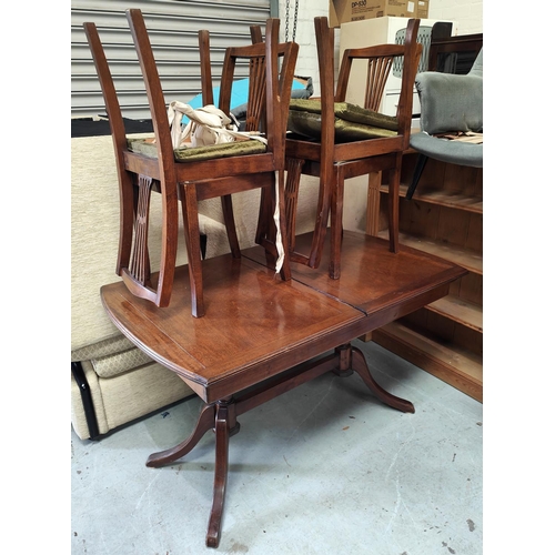 917 - An oak dresser with canted two height shelf back and two cupboards below; a pedestal dinning table a... 