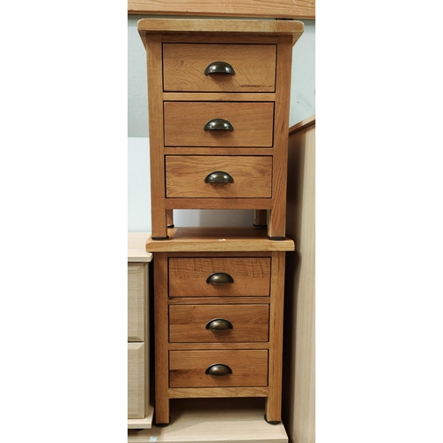 948 - A pair of light oak 3 height bedside tables