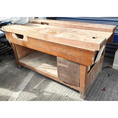 962 - A vintage wooden tool / work bench with loose plank top and space beneath, 150 x 80cm