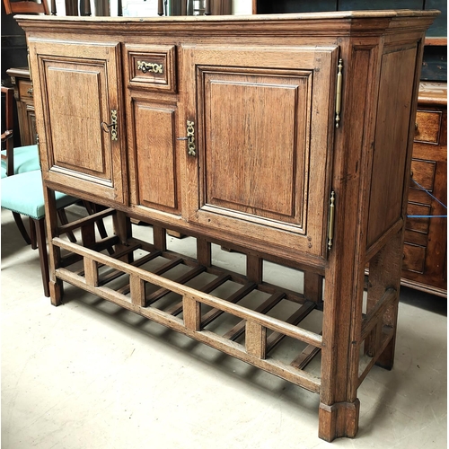 988 - An oak country made side cabinet with double doors, panelled decoration, small central spice drawer ... 