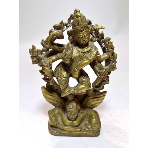 411 - A late 19th/early 20th century bronze Indian deity with multiple limbs, 15cm