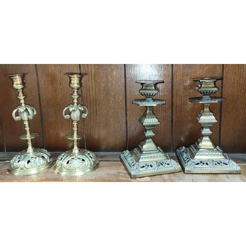 61A - An unusual pair of brass French style candlesticks and a similar pair of squared classical style can... 